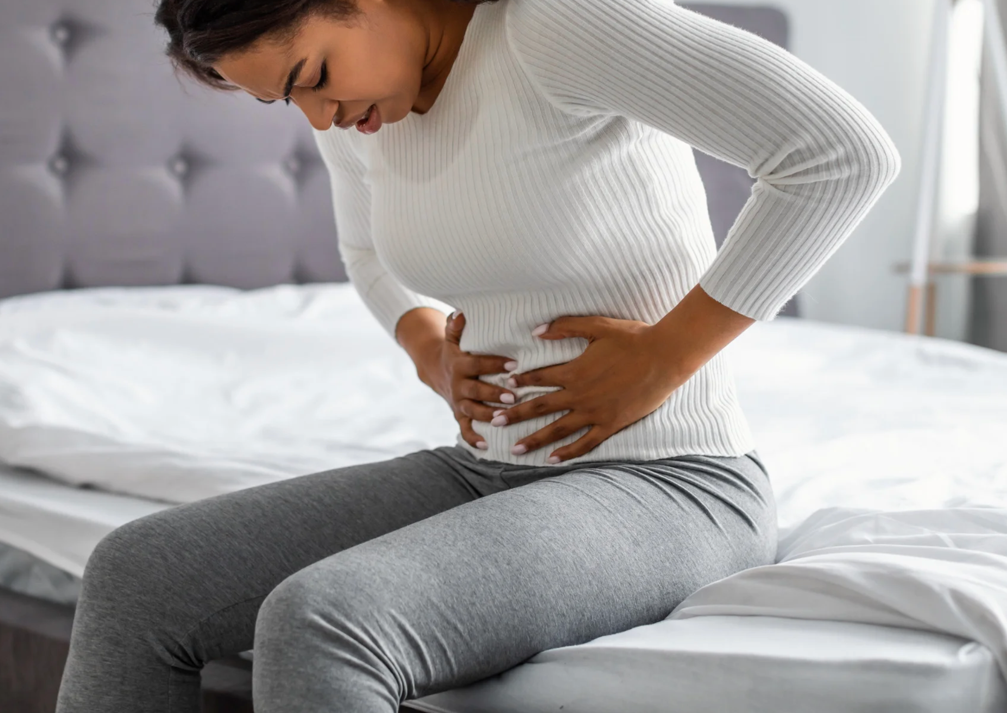 Woman holding stomach in pain